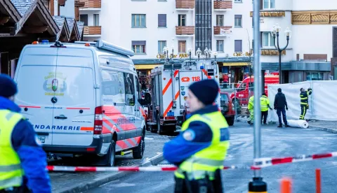 Police officers stand guard at the site of an explosion that ripped through a bar in Crans-Montana on January 1, 2026. Several people were killed and others injured when an explosion ripped through a bar in the luxury Alpine ski resort town of Crans Montana, Swiss police said early on January 1. (Photo by MAXIME SCHMID/AFP)
