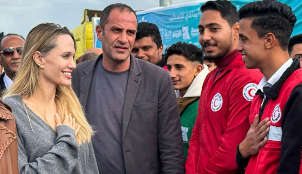 US actress Angelina Jolie greets an employee of the the Egyptian Red Crescent at the Egyptian Rafah border crossing, part of her visit to the North Sinai Governorate to inspect aid entering the Palestinian Gaza Strip, on January 2, 2026, following a two year war that was sparked by Hamas's October 7, 2023 attack on Israel, and which has left the majority of Gaza's 2.4 million people displaced and in need of aid. (Photo by AFP)