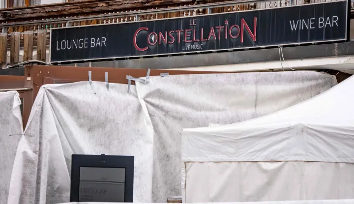 This photograph shows the entrance of the bar Le Constellation where a fire ripped through the venue during New Year's celebrations in the Alpine ski resort town of Crans-Montana killing around 40 people and injuring more than 100 others, in Crans-Montana on January 2, 2026. Investigators raced on January 2, 2026 to identify the victims of a fire that ripped through a bar in the Swiss Alps town of Crans-Montana, turning a New Year's celebration into one of the country's worst tragedies. Frederic Gisler, police commander in the Wallis canton in southwestern Switzerland, told reporters that authorities had counted "around 40 people who have died and around 115 injured, most of them seriously". (Photo by MAXIME SCHMID/AFP)