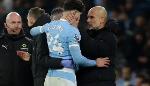 Soccer Football - Premier League - Manchester City v Chelsea - Etihad Stadium, Manchester, Britain - January 4, 2026 Manchester City's Josko Gvardiol with Manchester City manager Pep Guardiola REUTERS/Phil Noble EDITORIAL USE ONLY. NO USE WITH UNAUTHORIZED AUDIO, VIDEO, DATA, FIXTURE LISTS, CLUB/LEAGUE LOGOS OR 'LIVE' SERVICES. ONLINE IN-MATCH USE LIMITED TO 120 IMAGES, NO VIDEO EMULATION. NO USE IN BETTING, GAMES OR SINGLE CLUB/LEAGUE/PLAYER PUBLICATIONS. PLEASE CONTACT YOUR ACCOUNT REPRESENTATIVE FOR FURTHER DETAILS.. Photo: Phil Noble/REUTERS