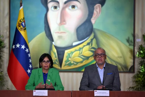 (FILES) Venezuela's Vice-President Delcy Rodriguez (L) speaks next to National Assembly President Jorge Rodriguez, during a meeting of the High Commission of Guyana Essequiba at the Foreign Ministry headquarters in Casa Amarilla in Caracas, on December 11, 2023. Venezuelan President Nicolas Maduro and his wife, Cilia Flores, were seized by US forces during a pre-dawn raid on January 3, 2026, in Caracas and taken to New York to face charges of "narcoterrorism." His fall puts the Chavista factions that have governed Venezuela for 27 years to the test. (Photo by Federico PARRA/AFP)