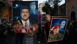 Supporters show paintings depicting ousted Venezuela's President Nicolas Maduro and former President Hugo Chavez (1999-2013) during a demonstration in Caracas on January 4, 2026, a day after he was captured in a US strike. Nicolas Maduro's congressman son called on January 4, 2026, for Venezuelans to take to the streets following his father's ouster by US forces and transfer to a New York jail. (Photo by Juan BARRETO/AFP)