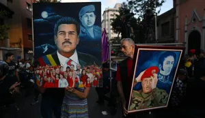 Supporters show paintings depicting ousted Venezuela's President Nicolas Maduro and former President Hugo Chavez (1999-2013) during a demonstration in Caracas on January 4, 2026, a day after he was captured in a US strike. Nicolas Maduro's congressman son called on January 4, 2026, for Venezuelans to take to the streets following his father's ouster by US forces and transfer to a New York jail. (Photo by Juan BARRETO/AFP)