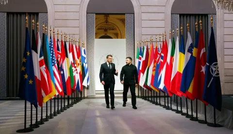 France's President Emmanuel Macron (L) and Ukraine's President Volodymyr Zelensky (R) talk as they arrive for the Coalition of the Willing meeting in Paris, at the Elysee Palace on January 6, 2026. The summit of the group of Ukraine supporters dubbed the "Coalition of the Willing" is the latest of several meetings planned for the new year as diplomatic efforts to end Europe's deadliest conflict since World War II have gained pace in recent weeks. (Photo by Yoan VALAT/POOL/AFP)
