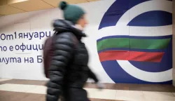 A commuter walks past an advertisement promoting Bulgaria's entry into the Eurozone in Sofia's subway on December 31, 2025, ahead of the country's adoption of the euro on January 1, 2026. (Photo by Nikolay DOYCHINOV/AFP)
