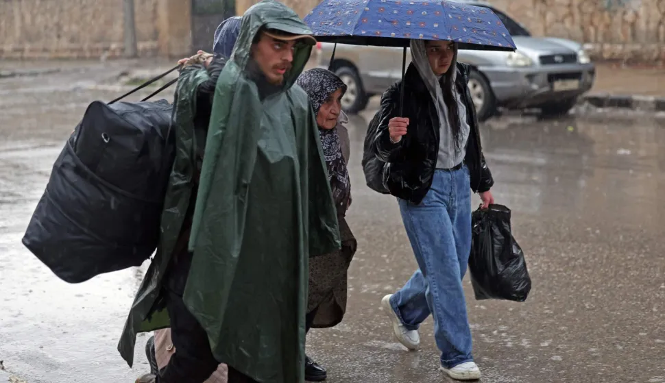 Residents of Aleppo's Sheikh Maqsoud area evacuate their neighbourhood after warnings from the Syrian army that called on civilians to get out of harms way, following the refusal of Kurdish fighter forces to leave Aleppo, on January 9, 2026. Syria's army warned on January 9 it would renew attacks against a Kurdish-majority district of Aleppo and urged residents to evacuate, state media reported, hours after a ceasefire was announced. (Photo by OMAR HAJ KADOUR/AFP)
