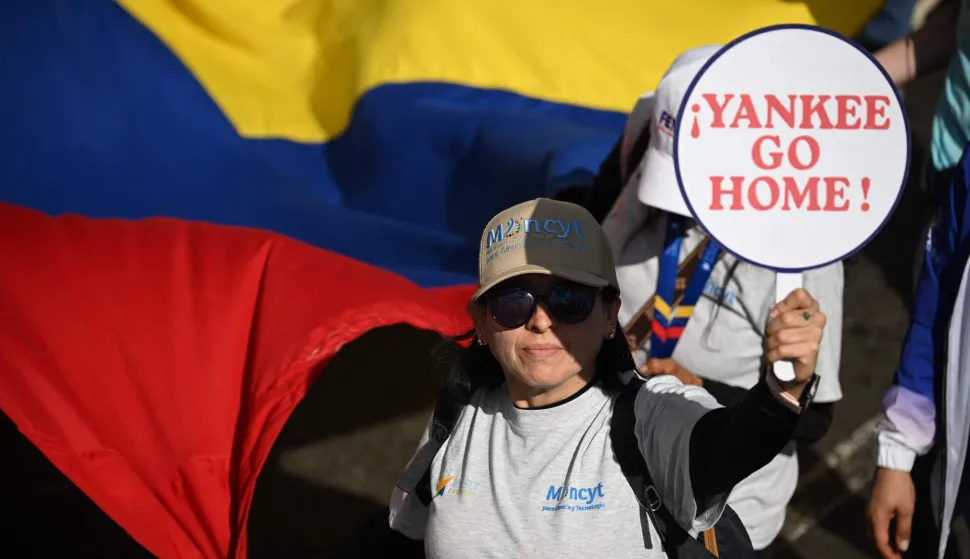A woman holds a banner during a march in Caracas on January 8, 2026, to demand the release of deposed Venezuelan president Nicolas Maduro and his wife Cilia Flores, snatched and taken to New York on January 3 to face trial on drug and weapons charges. Venezuela on January 8 announced the release of a "large number" of prisoners, some of them foreigners, in an apparent concession to the United States after its ouster of ruler Nicolas Maduro. (Photo by Federico PARRA/AFP)