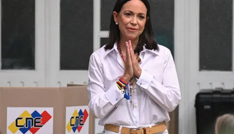 (FILES) Venezuelan opposition leader Maria Corina Machado gestures as she votes during the presidential election, in Caracas on July 28, 2024. On January 5, 2026, Venezuelan opposition leader Maria Corina Machado said she plans to return home "as soon as possible," and slammed the interim leader in Caracas. (Photo by Federico PARRA/AFP)