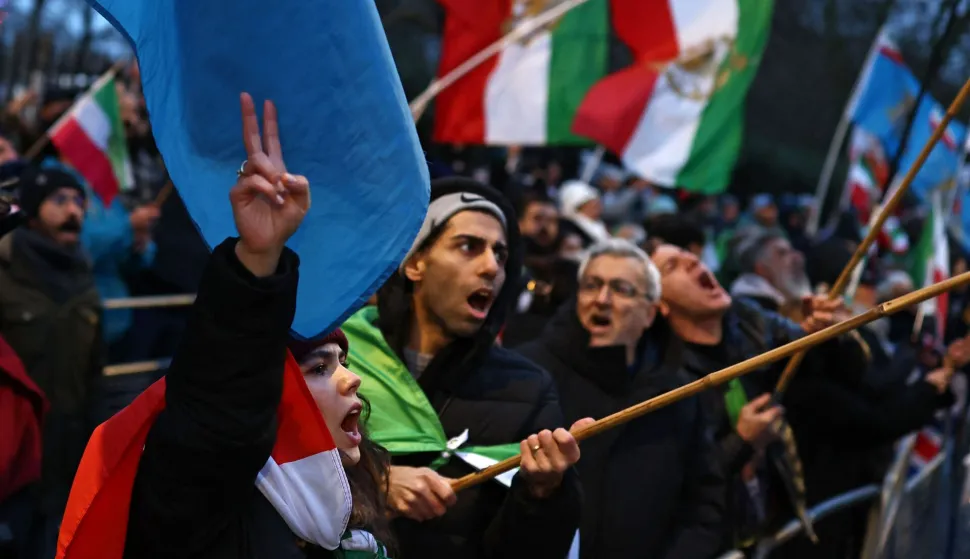Anti-Iranian regime protesters wave Iranian flags before the 1979 revolution with the Lion and Sun emblems during a gathering outside the Iranian Embassy, central London, on January 9, 2026. Iran FM says US, Israel 'directly intervening' in protests. Iran's foreign minister accused the United States and Israel on Friday of fuelling a growing protest movement in the country, while dismissing the possibility of direct foreign military intervention after US warnings over crackdowns on demonstrators. (Photo by Henry NICHOLLS/AFP)