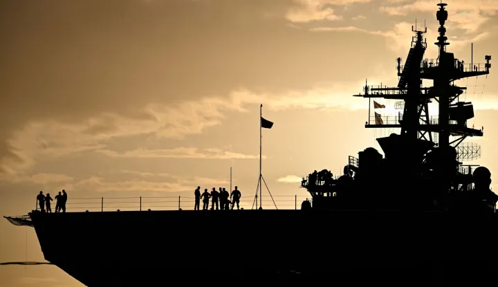 (FILES) The Wasp-class amphibious assault ship USS Iwo Jima (LHD7) is docked at Rafael Cordero Santiago Port of the America on December 16, 2025 in Ponce, Puerto Rico. US President Donald Trump said on January 3, 2026, that Venezuela's leader Nicolas Maduro was initially extracted by helicopter and was being held on the Iwo Jima, an amphibious assault ship that is part of a large US naval presence in the Caribbean. From there, he will be sent to New York. (Photo by Miguel J. Rodriguez Carrillo/AFP)