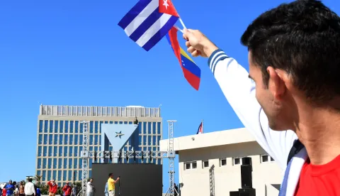 (260104) -- HAVANA, Jan. 4, 2026 (Xinhua) -- A protester holds Cuban and Venezuelan national flags in front of the U.S. embassy after an event condemning the U.S. military aggression against Venezuela in Havana, capital of Cuba, Jan. 3, 2026. (Photo by Joaquin Hernandez/Xinhua) Photo: JOAQUIN HERNANDEZ/XINHUA