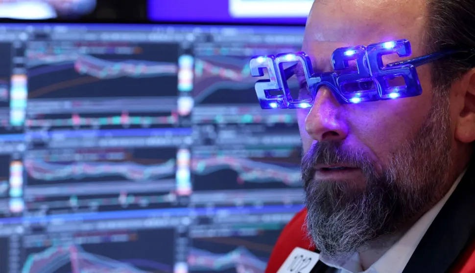 Trader Michael Pistillo wears "2026" glasses as he works on the floor of the New York Stock Exchange (NYSE) at the opening bell in New York on December 31, 2025. Wall Street's main indexes pulled back slightly on Wednesday, in a mild retreat that still sets the stage for a robust showing for all of 2025. (Photo by TIMOTHY A. CLARY/AFP)