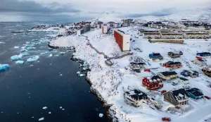 (FILES) This aerial view shows snow-covered buildings in Nuuk, Greenland, on March 7, 2025. Any US attack on a NATO ally would be the end of "everything", Denmark's Prime Minister Mette Frederiksen warned on January 5, 2026, after US President Donald Trump repeated his desire to annex Greenland. "If the United States decides to militarily attack another NATO country, then everything would stop -- that includes NATO and therefore post-World War II security," Frederiksen told Danish television network TV2. (Photo by Odd ANDERSEN/AFP)