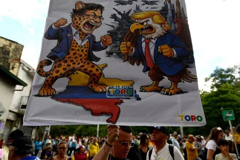 A sign depicting Colombian President Gustavo Petro and US President Donald Trump fighting is pictured during the March for Sovereignty and Democracy in Medellin, Colombia, on January 7, 2026. On January 5, Colombian President Gustavo Petro said he was ready to "take up arms" in the face of threats from US counterpart Donald Trump, who over the weekend seized the leader of neighboring Venezuela in a military strike. (Photo by JAIME SALDARRIAGA/AFP)