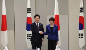 Japan's Prime Minister Sanae Takaichi (R) shakes hands with South Korea's President Lee Jae Myung at the start of their meeting in Nara, Nara Prefecture on January 13, 2026. (Photo by Issei Kato/POOL/AFP)