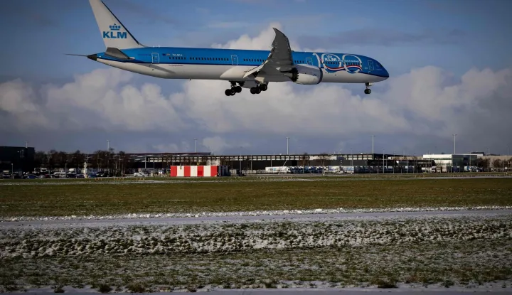 A plane of KLM airlines lands at the Schiphol Airport on January 4, 2026 as hundreds of flights have been canceled due to the winter weather. (Photo by Robin van Lonkhuijsen/ANP/AFP)/Netherlands OUT