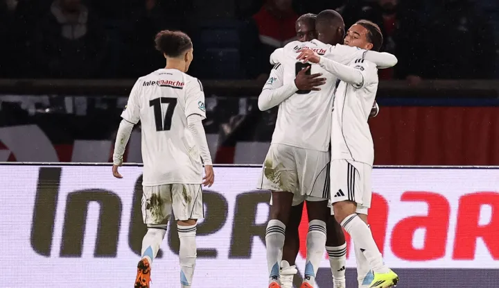 Paris FC's French midfielder #14 Jonathan Ikone (2L) celebrates with teammates after scoring his team's first goal during the French Cup round of 32 football match between between Paris Saint-Germain (PSG) and Paris FC at the Parc des Princes stadium in Paris on January 12, 2026. (Photo by Anne-Christine POUJOULAT/AFP)