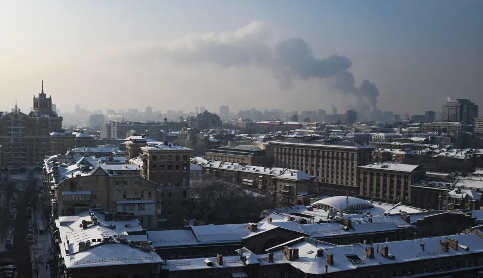 This photograph shows snow-covered roofs on buildings in Kyiv on January 14, 2026, amid the Russian invasion of Ukraine. (Photo by Sergei GAPON/AFP)