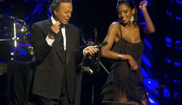 (FILES) Spanish singer Julio Iglesias (L) performs at the Ahoy arena in Rotterdam, on June 9, 2013. Two former employees of Julio Iglesias sue him before the Spanish justice, after denouncing in a journalistic investigation published this January 13, 2026 alleged assaults and sexual harassment by the Spanish singer. Legal sources confirmed to AFP that a complaint against Iglesias was filed on January 5 and is being examined. (Photo by PAUL BERGEN/ANP/AFP)