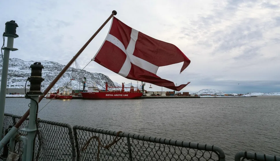 The Danish flag flies form the deck of the HDMS Knud Rasmussen Royal Danish Navy patrol vessel, moored at the harbour in Nuuk, Greenland on January 16, 2026. Denmark's prime minister said on January 15, 2026 that the US ambition to take control of Greenland remained "intact" and that there were still a "fundamental disagreement" between the countries, despite high-stakes White House talks. (Photo by Alessandro RAMPAZZO/AFP)