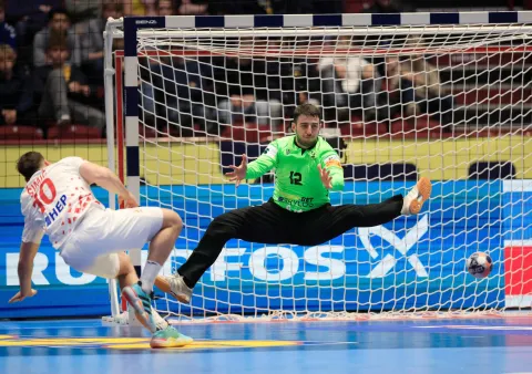 Croatia's pivot #10 Josip Simic scores past Georgia's goalkeeper #12 Zurab Tsintsadze during the EHF Euro 2026 group E preliminary round handball match between Croatia and Georgia in Malmo, Sweden, on January 17, 2026. (Photo by Andreas Hillergren/TT/TT News Agency/AFP)/Sweden OUT