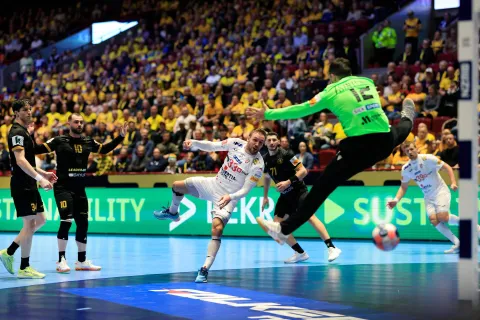 Croatia's centre back #33 Luka Cindric scores past Georgia's goalkeeper #12 Zurab Tsintsadze during the EHF Euro 2026 group E preliminary round handball match between Croatia and Georgia in Malmo, Sweden, on January 17, 2026. (Photo by Andreas Hillergren/TT/TT News Agency/AFP)/Sweden OUT