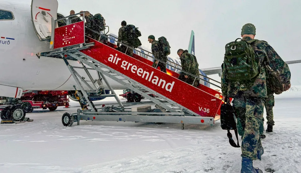 Military personnel from the German armed Forces Bundeswehr board the Icelandair flight leaving Nuuk airport for Reykjavik on January 18, 2026 in Nuuk, Greenland. US President Donald Trump escalated his quest to acquire Greenland, threatening multiple European nations with tariffs of up to 25 percent until his purchase of the Danish territory is achieved. Trump's threats came as thousands of people protested in the capital of Greenland against his wish to acquire the mineral-rich island at the gateway to the Arctic. (Photo by Alessandro RAMPAZZO/AFP)