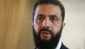 Syria's President Ahmed al-Sharaa speaks after signing an agreement at the Presidential Palace in Damascus on January 18, 2026. Syrian President Ahmed al-Sharaa on January 18, announced an agreement with the chief of the Kurdish-led Syrian Democratic Forces that includes a ceasefire after government forces advanced in Kurdish-held areas of the north and east. (Photo by Handout/AFP)