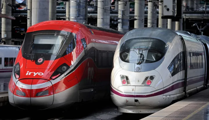 (FILES) High-speed train AVE of the Spanish national railways company RENFE (R) is seen next to high-speed train of private operator Iryo of ILSA company at the Atocha station in Madrid, on February 26, 2023. At least five people have been killed after a train derailed on January 18, 2026 in the southern Spanish province of Cordoba following a collision with another train, a police spokesman told AFP. (Photo by Thomas COEX/AFP)