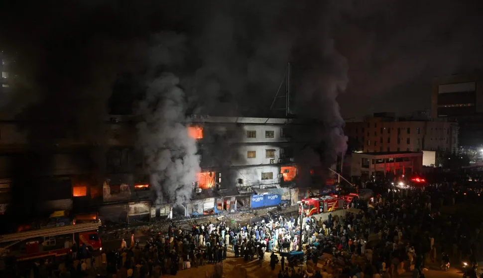 TOPSHOT - Firefighters douse a fire that broke out at a shopping mall in Karachi on January 18, 2026. (Photo by Rizwan TABASSUM/AFP)