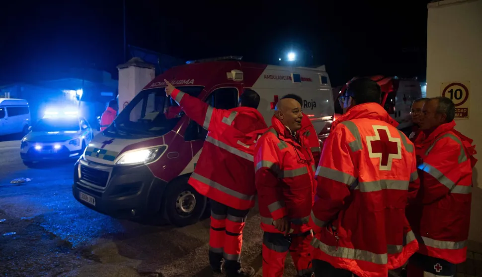 Members of the Red Cross work after a train accident in Adamuz, southern Spain, early on January 19, 2026. Spain reeled from a collision between two high-speed trains in the southern region of Andalusia that killed 21 people and injured more than 70, with the Prime Minister Pedro Sanchez lamenting a "night of deep pain" in the early hours of January 19, 2026. (Photo by Jorge GUERRERO/AFP)