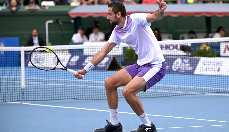 Croatia's Marin Cilic hits a return to USA's Learner Tien during their men's singles match at the Kooyong Classic tennis tournament in Melbourne on January 14, 2026. (Photo by William WEST/AFP)/-- IMAGE RESTRICTED TO EDITORIAL USE - STRICTLY NO COMMERCIAL USE --