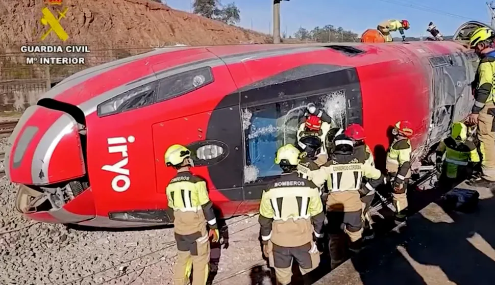 TOPSHOT - In this still image from video taken and released on January 19, 2026 by the Spain's Guardia Civil, emergency workers are seen at the site where a high-speed Iryo train derailed and was hit by another train as rescue efforts continue in Adamuz, southern Spain, on January 19, 2026. At least 39 people died and more than 120 injured in the deadliest train accident in Spain in over a decade.The crash happened on Sunday evening when a train operated by rail company Iryo travelling from Malaga to Madrid derailed near Adamuz, crossing onto the other track where it crashed into an oncoming train, which also derailed. (Photo by Handout/Guardia Civil/AFP)/RESTRICTED TO EDITORIAL USE - MANDATORY CREDIT "AFP PHOTO/GUARDIA CIVIL" - HANDOUT - NO MARKETING NO ADVERTISING CAMPAIGNS - DISTRIBUTED AS A SERVICE TO CLIENTS