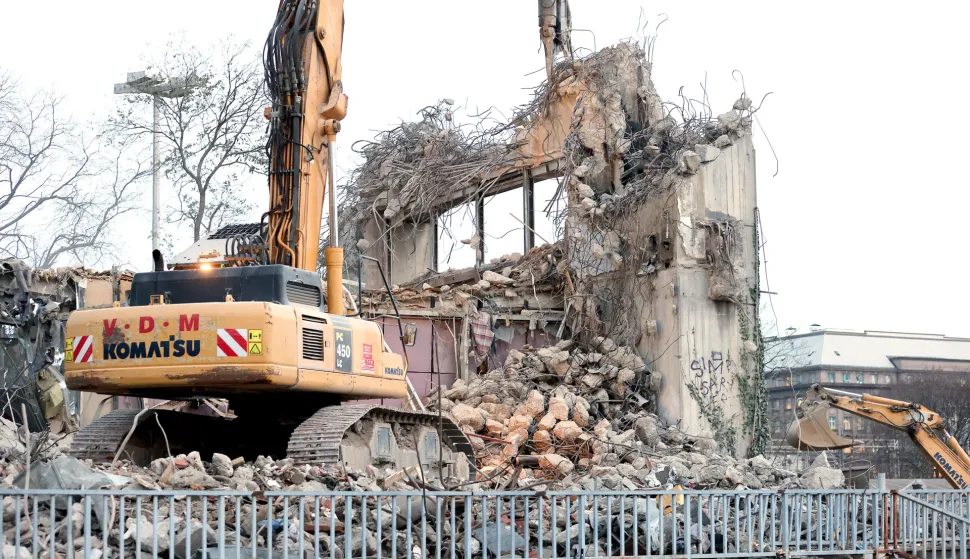 22.12.2023., Zagreb - Rusenje stare zgrade Zagrebacke banke u Paromlinskoj ulici sada je u osjetljivoj fazi jer se radi na dijelu koji je najblizi autobusnom terminalu. Da bi se izbjeglo padanje dijelova zgrade na prolaznike dok jedan stroj rusi drugi drzi zastitnu barijeru. Photo: Patrik Macek/PIXSELL