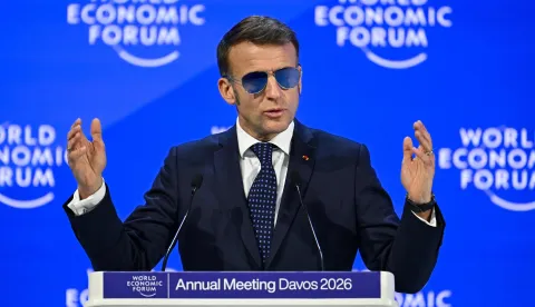 TOPSHOT - France's President Emmanuel Macron gestures as he delivers a speech during the World Economic Forum (WEF) annual meeting in Davos on January 20, 2026. The World Economic Forum takes place in Davos from January 19 to January 23, 2026. (Photo by Fabrice COFFRINI/AFP)