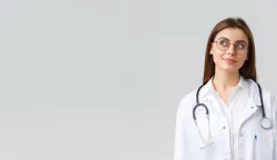 Healthcare workers, medicine, insurance and covid-19 pandemic concept. Dreamy young talented doctor in white scrubs and glasses, looking upper left corner thoughtful and smiling, imaging something.