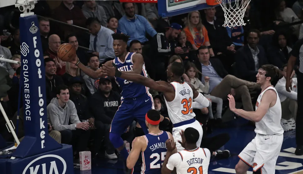 epa07280774 Philadelphia 76ers guard Jimmy Butler (L) is forced to pass by New York Knicks forward Noah Vonleh (C) in the first half of the NBA basketball game between the Philadelphia 76ers and the New York Knicks at Madison Square Garden in New York, New York, USA, 13 January 2019. EPA/PETER FOLEY SHUTTERSTOCK OUT