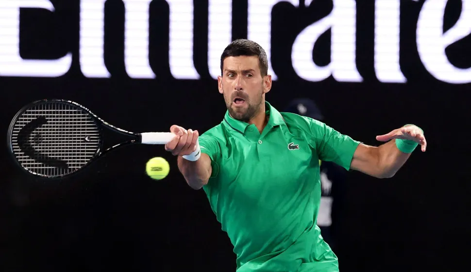 Serbia's Novak Djokovic hits a return to Spain?s Pedro Martinez during their men's singles match on day two of the Australian Open tennis tournament in Melbourne on January 19, 2026. (Photo by DAVID GRAY/AFP)/-- IMAGE RESTRICTED TO EDITORIAL USE - STRICTLY NO COMMERCIAL USE --