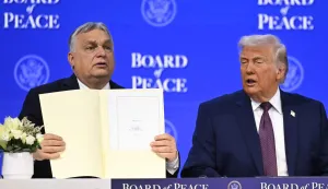 Hungary's Prime Minister Viktor Orban (L) holds a founding charter next to US President Donald Trump at the "Board of Peace" meeting during the World Economic Forum (WEF) annual meeting in Davos on January 22, 2026. US President Donald Trump will show off his new "Board of Peace" at Davos on January 22, 2026 burnishing his claim to be a peacemaker a day after backing off his own threats against Greenland. Originally meant to oversee the rebuilding of Gaza after the war between Hamas and Israel, the board's charter does not limit its role to the Strip, and has sparked concerns that Trump wants it to rival the United Nations. (Photo by Fabrice COFFRINI/AFP)
