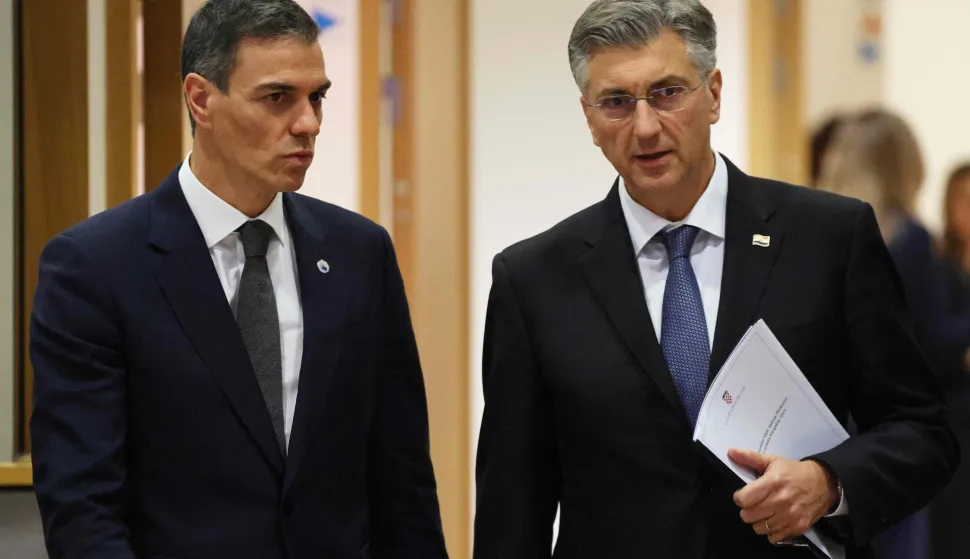 Spain's Prime Minister Pedro Sanchez (L) and Croatia's Prime Minister Andrej Plenkovic arrive to attend a roundtable meeting of the European Council to discuss recent developments in transatlantic relations, at the European headquarters in Brussels, on January 22, 2026. EU leaders meet on January 22, 2026, for an emergency summit on threats by US President to impose tariffs on countries opposed to his push to take Greenland, with crisis talks in Brussels coming to weigh potential countermeasures against the United States. (Photo by Ludovic MARIN/AFP)