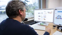 PRODUCTION - 29 November 2023, Lower Saxony, Hanover: Oliver Brockmann, chief inspector and investigator in the cybercrime/child pornography department of the State Criminal Police Office of Lower Saxony, sits in his office at the State Criminal Police Office of Lower Saxony in front of a monitor on which the interface of the "Tracebook KiPo" software developed by the LKA can be seen with demo photo files (posed scene). Photo: Michael Matthey/dpa Photo: Michael Matthey/DPA