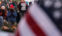 People mourn at a makeshift memorial in the area where 37-year-old Alex Pretti was shot dead by federal immigration agents earlier in the day in Minneapolis, Minnesota, on January 24, 2026. Federal immigration agents shot dead a man in Minneapolis on Saturday, in the second fatal shooting of a civilian during the Trump administration's unprecedented operation in the city, sparking fresh protests and outrage from state officials. The death came less than three weeks after US citizen Renee Good was shot and killed by an ICE officer. (Photo by ROBERTO SCHMIDT/AFP)