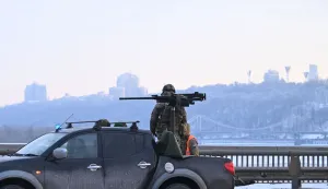 A Ukrainian serviceman stands next to a truck equipped with a machine gun during an air raid alert in Kyiv on January 24, 2026, amid the Russian invasion of Ukraine. (Photo by Sergei GAPON/AFP)