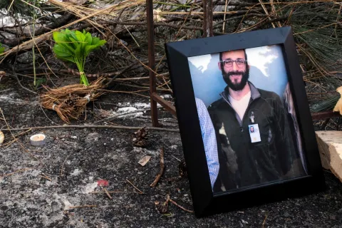 TOPSHOT - A photograph of 37-year-old Alex Pretti can be seen at a makeshift memorial in the area where he was shot dead by federal immigration agents earlier in the day in Minneapolis, Minnesota, on January 24, 2026. Federal immigration agents shot dead a man in Minneapolis on Saturday, in the second fatal shooting of a civilian during the Trump administration's unprecedented operation in the city, sparking fresh protests and outrage from state officials. The death came less than three weeks after US citizen Renee Good was shot and killed by an ICE officer. (Photo by ROBERTO SCHMIDT/AFP)