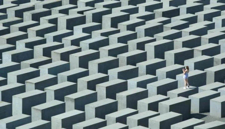 epa04874196 A visitor takes a picture as she stands on one of the concrete steles of the 'Memorial to the Murdered Jews of Europe', also known as the Holocaust Memorial, in&nbsp;Berlin, Germany, 06 August 2015. EPA/JOERG&nbsp;CARSTENSEN