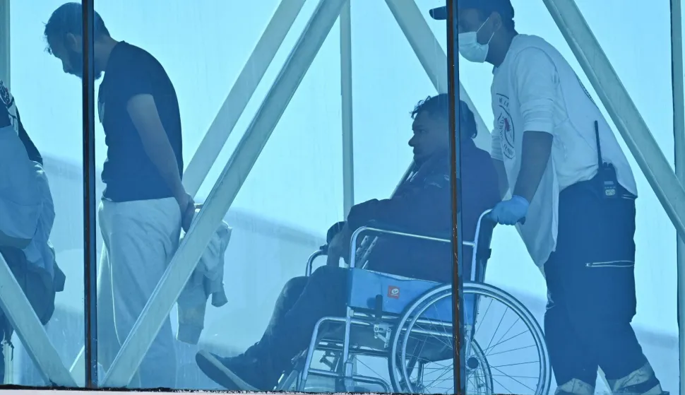 A Venezuelan migrant deported from the United States arrives in a wheelchair at Simon Bolivar International Airport in Maiquetia, Venezuela on January 19, 2026. (Photo by Juan BARRETO/AFP)