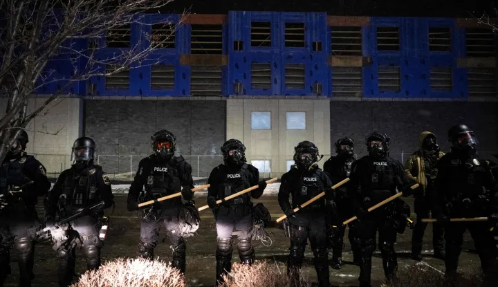 Minneapolis police form a line near protestors gathered for a ?Goodbye Bovino Noise Demo? rally in front of the hotel where they believe US Customs and Border Protection Commander Gregory Bovino to be staying, in Maple Grove, in the outskirts of Minneapolis, Minnesota, on January 26, 2026. US media reported that controversial Border Patrol commander Gregory Bovino was leaving Minneapolis -- though the US Department of Homeland Security (DHS) has vehemently denied he is being let go. On January 24, federal agents shot and killed Alex Pretti, a 37-year-old ICU nurse, while scuffling with him on an icy roadway in Minneapolis, less than three weeks after an immigration officer fired on Renee Good, also 37, killing her in her car. US President Donald Trump blamed their deaths on Democratic "chaos," as his administration faced intensifying pressure over its mass immigration crackdown in Minneapolis. (Photo by ROBERTO SCHMIDT/AFP)