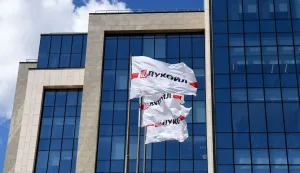 (FILES) Flags with the logo of Russia's Lukoil oil giant fly outside its headquarters in downtown Moscow on June 18, 2019. Russia's oil giant Lukoil, sanctioned by Washington over the Ukraine war, said on January 29, 2026 that it will sell its foreign assets to the US investment firm The Carlyle Group. (Photo by Kirill KUDRYAVTSEV/AFP)
