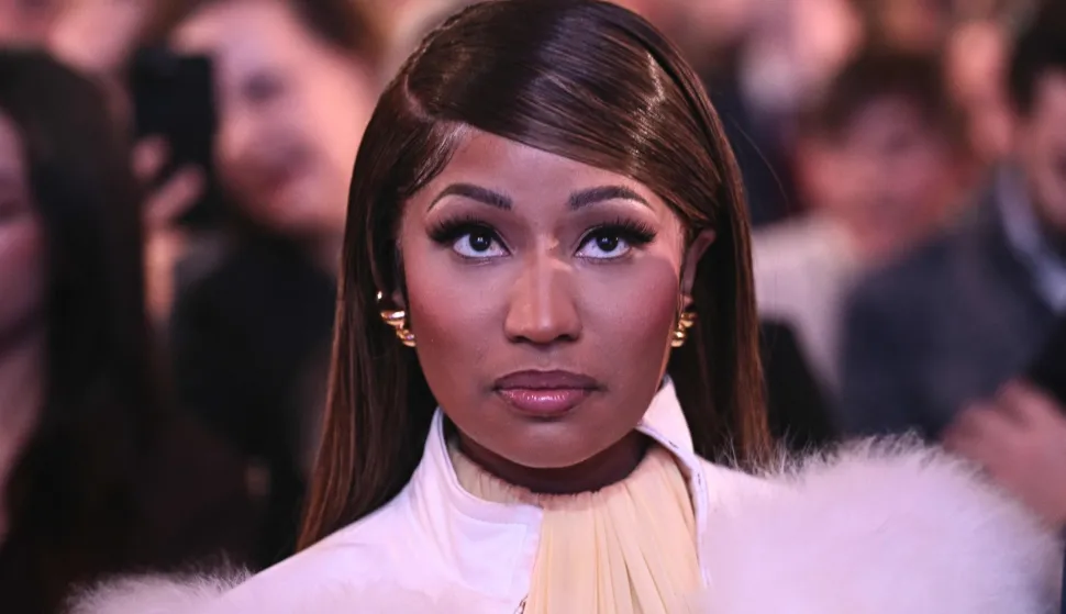 Trinidadian rapper and singer-songwriter Nicki Minaj looks on as US President Donald Trump speaks about 'Trump Accounts' at the Andrew W. Mellon Auditorium in Washington, DC, on January 28, 2026. (Photo by Brendan SMIALOWSKI/AFP)
