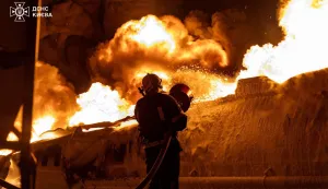 In this handout photograph taken and released by the Ukrainian Emergency Service on January 24, 2026, a Ukrainian rescuer works to extinguish a burning petrol truck following an air attack in Kyiv, amid the Russian invasion of Ukraine. Russian strikes killed one person and injured 23 others in Ukraine's capital and the northeastern city of Kharkiv overnight, authorities said early on January 24, 2026. (Photo by Handout/UKRAINIAN EMERGENCY SERVICE/AFP)/RESTRICTED TO EDITORIAL USE - MANDATORY CREDIT "AFP PHOTO/UKRAINIAN EMERGENCY SERVICE" - NO MARKETING NO ADVERTISING CAMPAIGNS - DISTRIBUTED AS A SERVICE TO CLIENTS